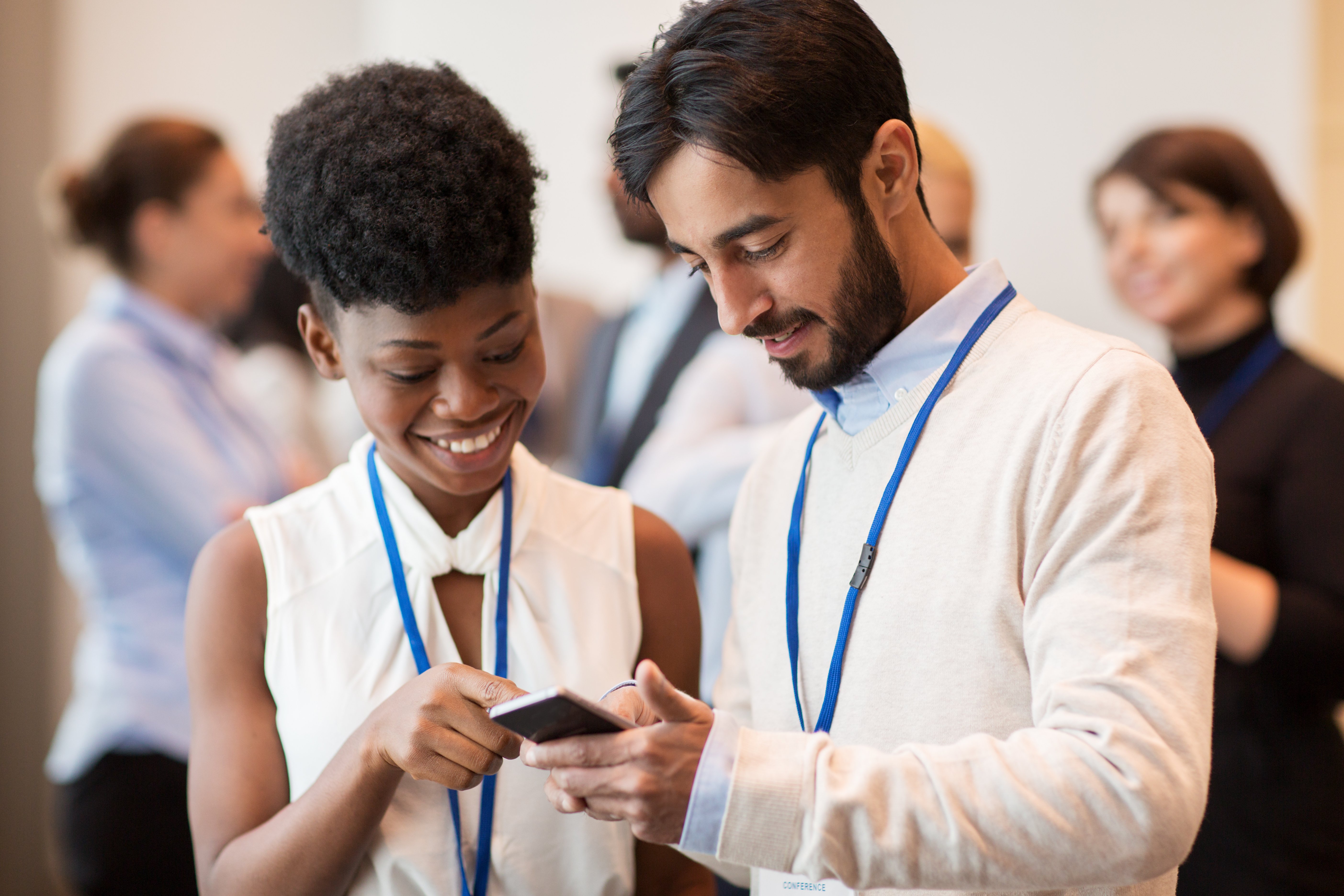 event-attendees-looking-at-phone
