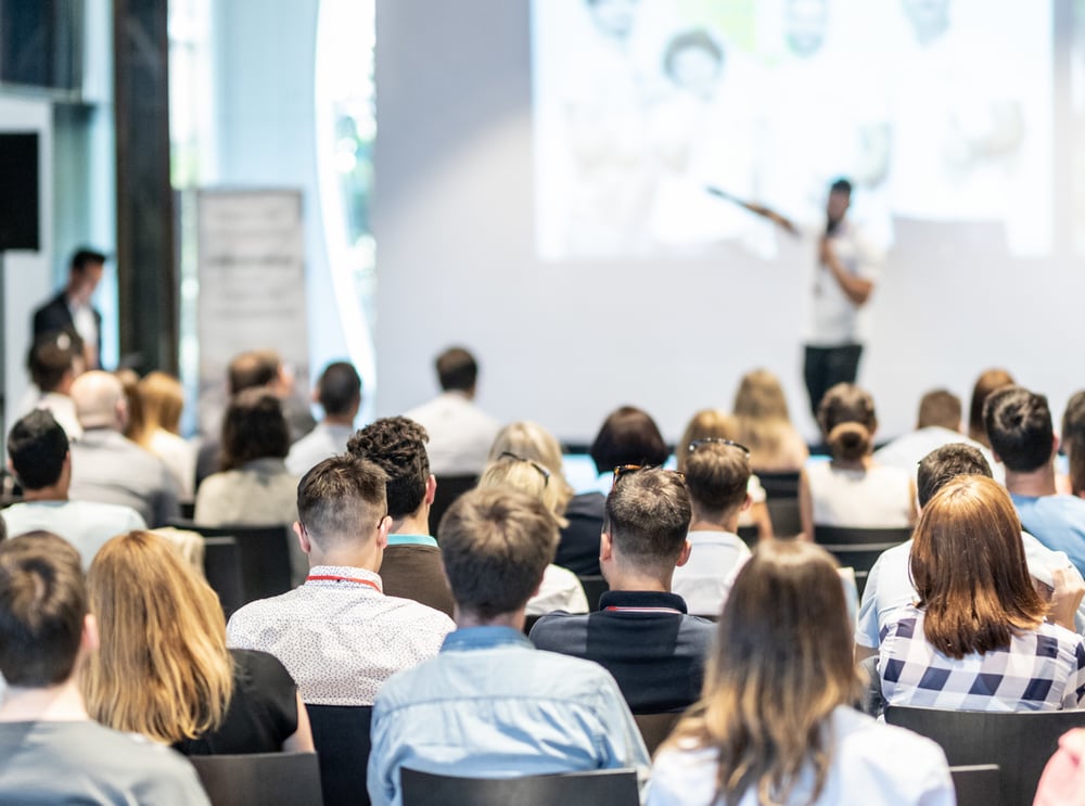 large-group-watching-speaker-with-screen-1
